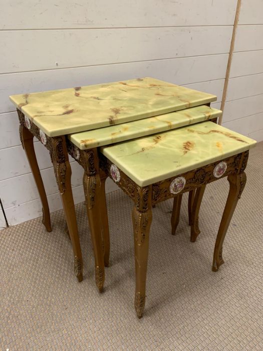 A nest of giltwood tables, inlaid with porcelain mounts and scroll details to side and legs (Largest - Image 8 of 9