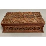 A carved Chinese box with dragon motif.