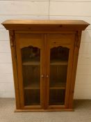 A Pine wall cabinet, with glazed front.(95 cm h x 71 cm w)