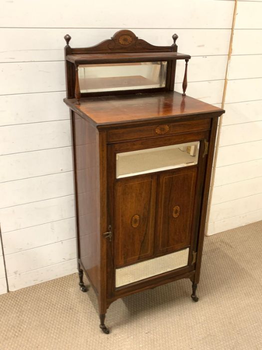 A mahogany music cabinet with mirror glass (H124cm W53cm D38cm)