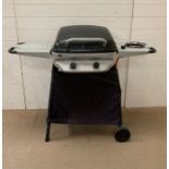 A gas barbecue with hob burner to side