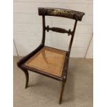 A brass inlay Regency dining chair, sabre legged