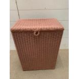 A Lloyd Loom lusty pink storage bin (H54cm W39cm D25cm)