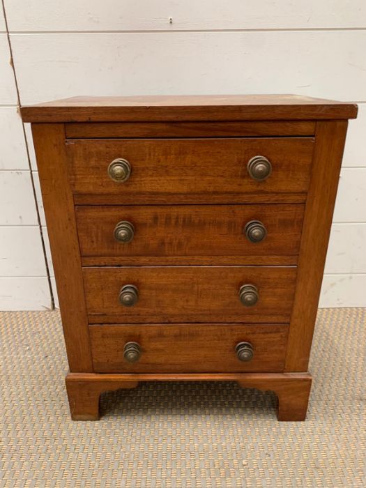 A sales man size chest of drawers on bracket feet (H52cm W39cm D28cm)