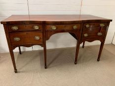 An Edwardian mahogany sideboard on square tapered legs ending in spate feet (H92cm W177cm D77cm)