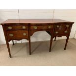 An Edwardian mahogany sideboard on square tapered legs ending in spate feet (H92cm W177cm D77cm)