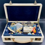 A jewellery box containing a wide selection of costume jewellery including fashion rings on