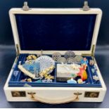 A jewellery box containing a wide selection of costume jewellery including fashion rings on