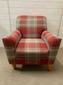 A contemporary armchair in tartan fabric