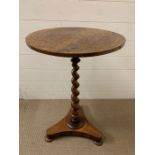 A rosewood occasional table on spiral centre support (H72cm Dia45cm)