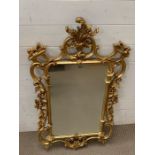 A Morris mirror with scroll work to frame (H110cm W58cm)