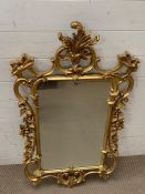 A Morris mirror with scroll work to frame (H110cm W58cm)