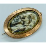 A late 18th century gold mourning brooch with weaved hair to one side and ivory decoted plaque to