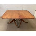 A George III mahogany 2-pillar dining table with rounded corners,crossbanding ebony stringing and