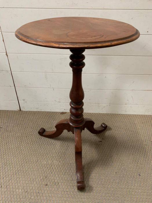 A mahogany occasional table on turn centre support on tri pod base