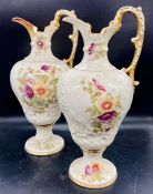 A pair of Ewer, high handled, painted with floral decoration