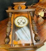 A mahogany wall hanging clock