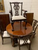 A mahogany dining table with a set of six Chippendale style dining chairs