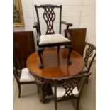 A mahogany dining table with a set of six Chippendale style dining chairs