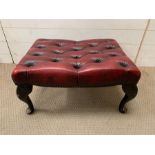 A leather button footstool (H32cm W60cm D48cm)