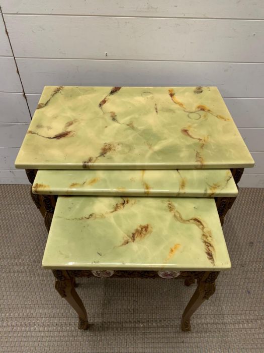 A nest of giltwood tables, inlaid with porcelain mounts and scroll details to side and legs (Largest - Image 2 of 9