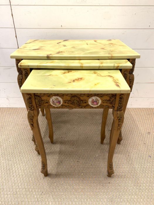 A nest of giltwood tables, inlaid with porcelain mounts and scroll details to side and legs (Largest - Image 3 of 9