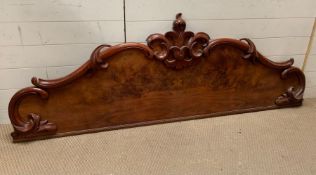 A mahogany carved headboard