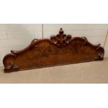 A mahogany carved headboard