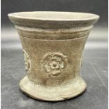 A Bronze mortar with a Tudor rose embossed design.