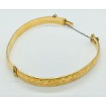 An 9ct gold bangle with metal core