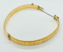 An 9ct gold bangle with metal core