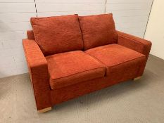 A two seater sofa bed in terra chenille fabric