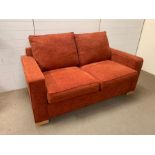 A two seater sofa bed in terra chenille fabric