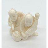 Japanese Ivory Netsuke men with a fish.