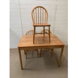 A Mid Century table and three Ercol chairs