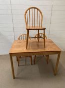 A Mid Century table and three Ercol chairs