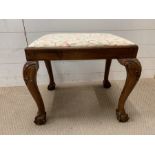 A George II walnut fruitwood stool on ball and claw feet