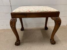 A George II walnut fruitwood stool on ball and claw feet