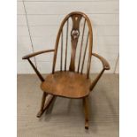 An Ercol rocking spindle back chair