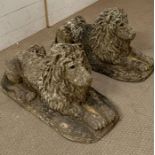 Two stone lion statues with glass eyes