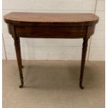 A Victorian card table, decorated with ebonised banding raised turned legs (H73cm W89cm D45cm)