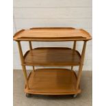 A three tier blonde Ercol trolley (H78cm W70cm)