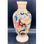 A cream vase with floral design to side, makers mark to base