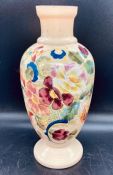 A cream vase with floral design to side, makers mark to base