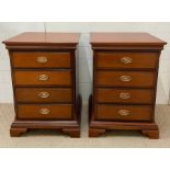 A pair of four drawer mahogany bedside cabinets