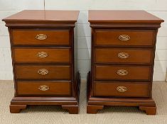 A pair of four drawer mahogany bedside cabinets