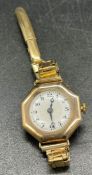 A 9ct gold Ladies watch on a rolled gold strap.
