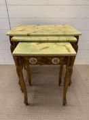A nest of giltwood tables, inlaid with porcelain mounts and scroll details to side and legs (Largest