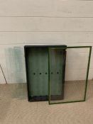 A wall hanging display cabinet with glass shelves