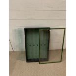 A wall hanging display cabinet with glass shelves